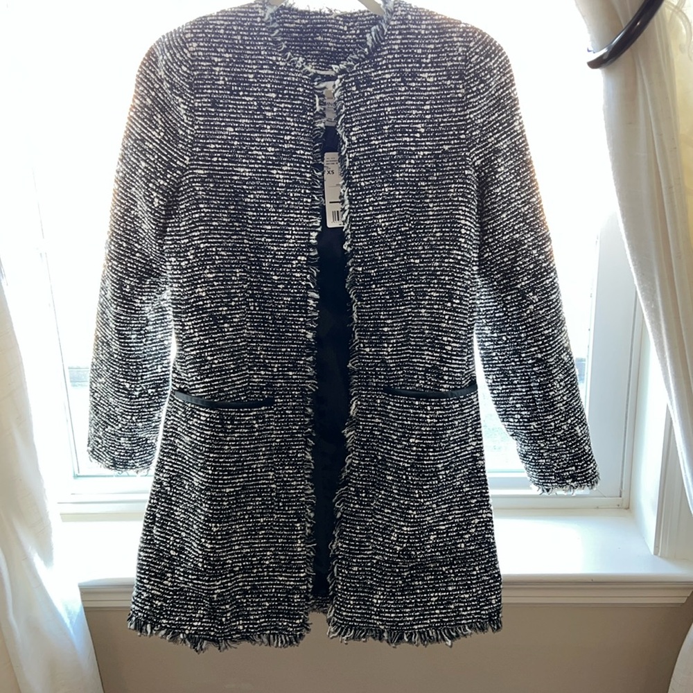 Long jacket with fringe details and 2 front pockets.
